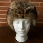 Skin brush alongside a coon skin hat and raccoon skin hat